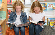 Two girls reading books