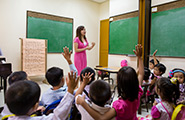 Primary teacher at the front of a primary class